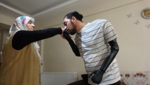 Biyonik kollarıyla anne ve babasının elini öptü